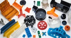 Various colored plastic injection molded parts are arranged on the surface.