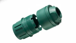 Two green plastic injection molded parts designed to fit together, showcasing precise engineering and manufacturing quality.