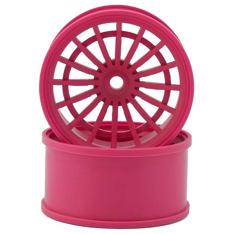 Pink plastic wheel rims with a spoke design, stacked together, showcasing their detailed structure.