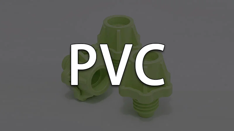Green plastic PVC pipe fittings arranged on a plain background.