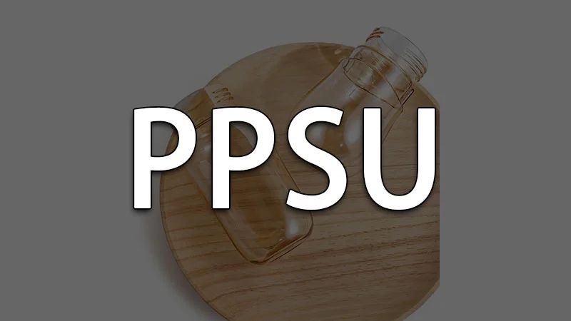 PPSU plastic bottle prototypes on a wooden surface, highlighting durability and clarity.