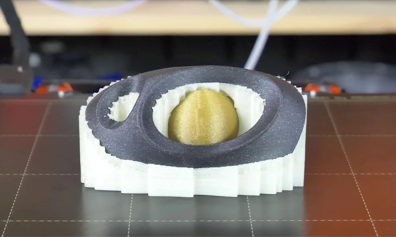 3D printed object with complex support structure, showcasing intricate design and precision manufacturing.