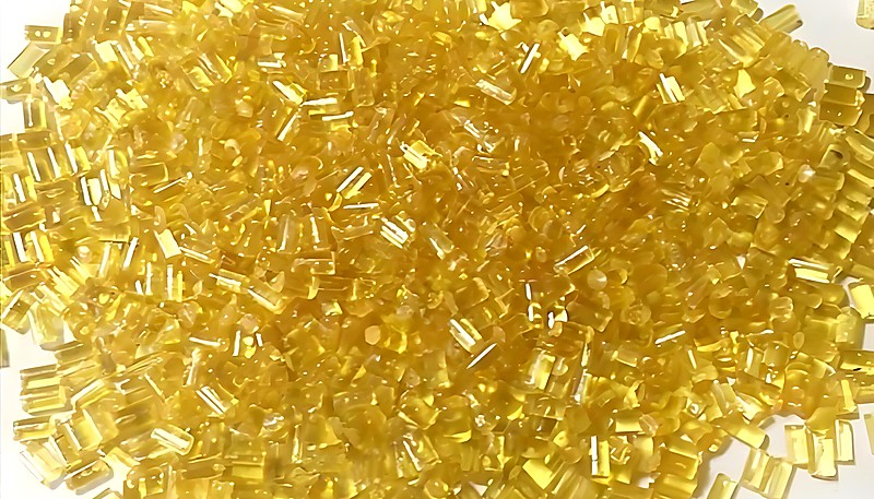 Yellow translucent plastic resin pellets