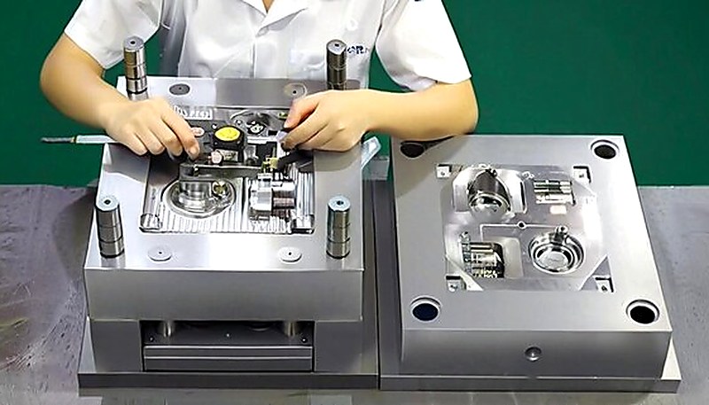 Engineer measuring injection molded part dimensions