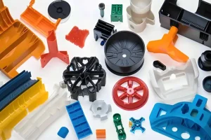 Various colored plastic injection molded parts are arranged on the surface.