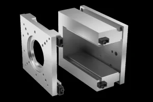 Two metal components of an injection mold separated, showing precision engineering and design.