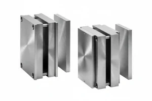 Two metallic injection mold components with a polished finish, displaying industrial precision and high-quality craftsmanship.