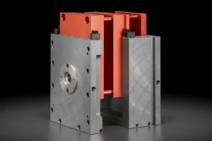 Close-up of precision injection mold tooling with red and metallic components, showcasing high-quality engineering.