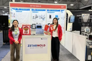 Zetar Mold Trade Show Booth Display Display booth of Zetar Mold featuring informational posters and flags at a trade show with industrial exhibition setup.